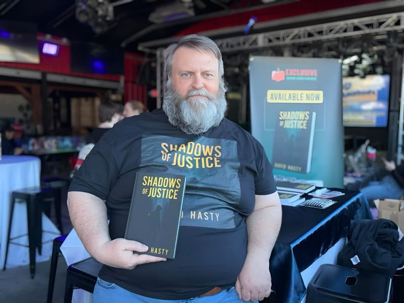 David with a copy of Shadows of Justice